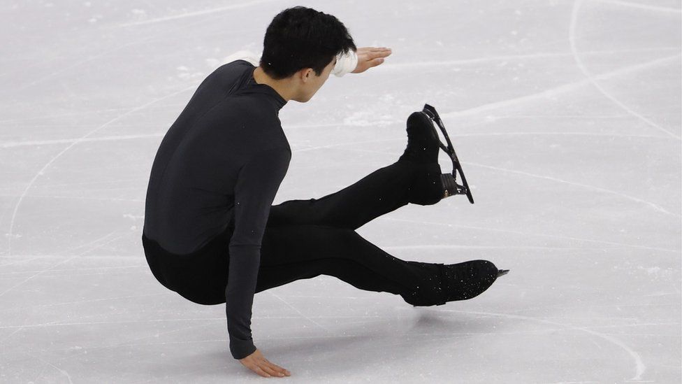 Nathan Chen tumbles during his performance