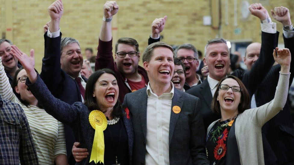 Sarah Olney with her husband Ben and Lib Dem supporters