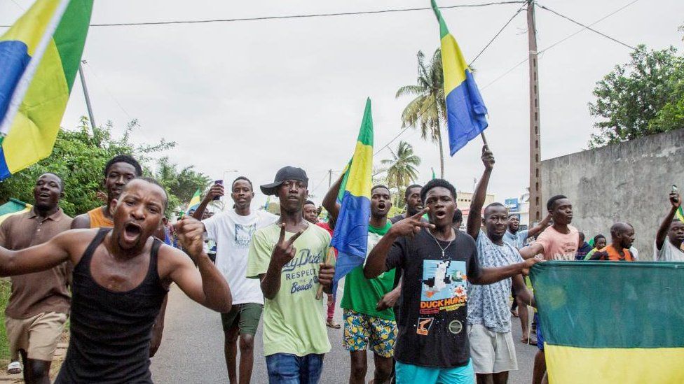 People celebrate in support of the putschists in a street of Port-Gentil, Gabon