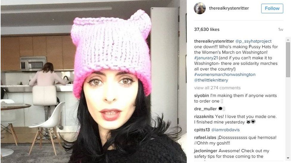 A screenshot of actress Krysten Ritter's Instgram account, showing her seated and wearing a bright pink pussyhat. The caption asks "who's making Pussy Hats for the Women's March on Washington!?"