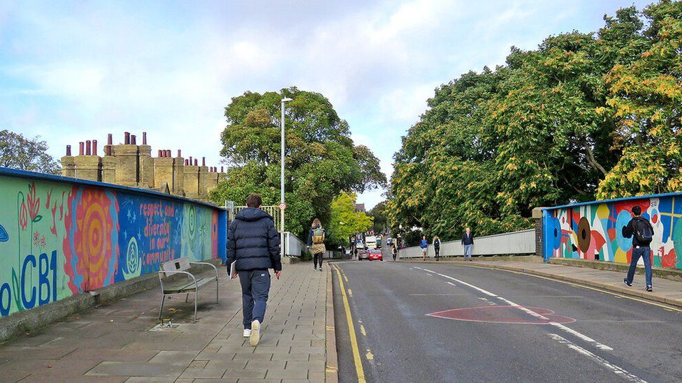 Mill Road in Cambridge with pedestrians walking across