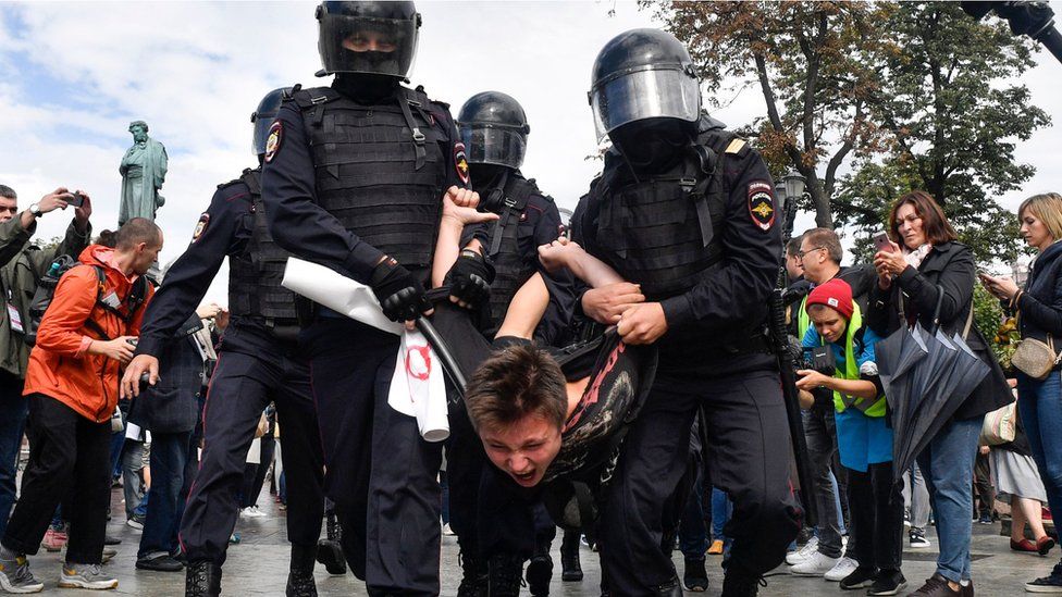 Riot police officers detain a participant of an unsanctioned rally urging fair elections at Moscow"s Pushkinskaya Square on August 3, 2019.