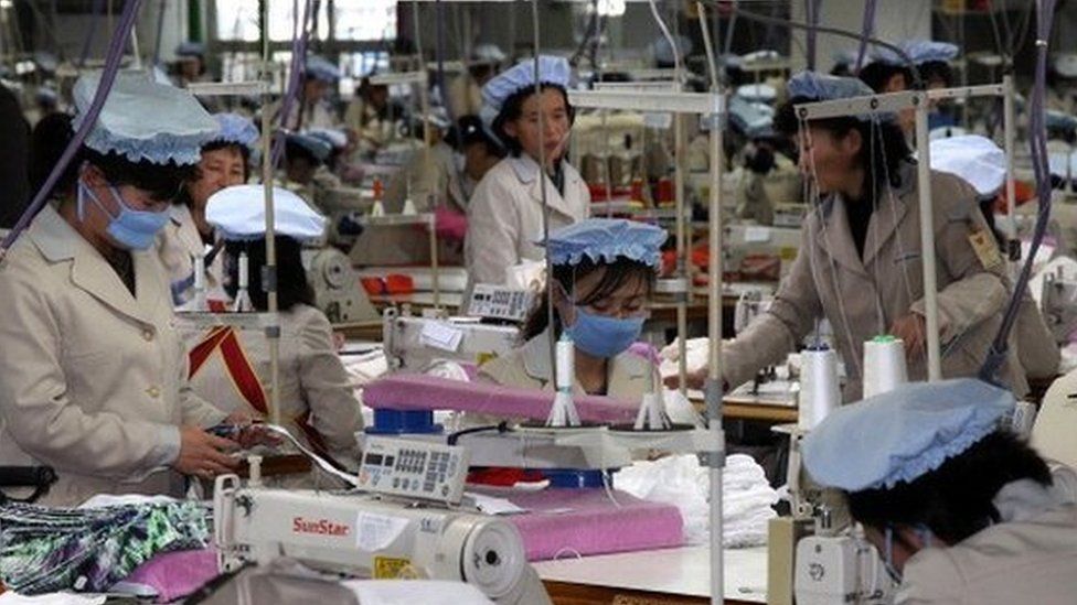 North Korean employees work at the assembly line of the factory of South Korean company at the Kaesong industrial complex on December 19, 2013 in Kaesong,