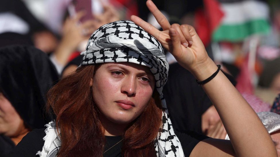 A woman wearing a the keffiyeh and making a victory sign takes part in pro-Palestinian protest Rabat, Morocco - Sunday 10 December 2023