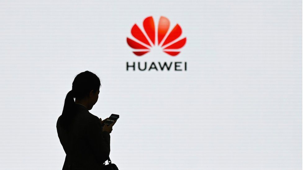 A staff member of Huawei uses her mobile phone