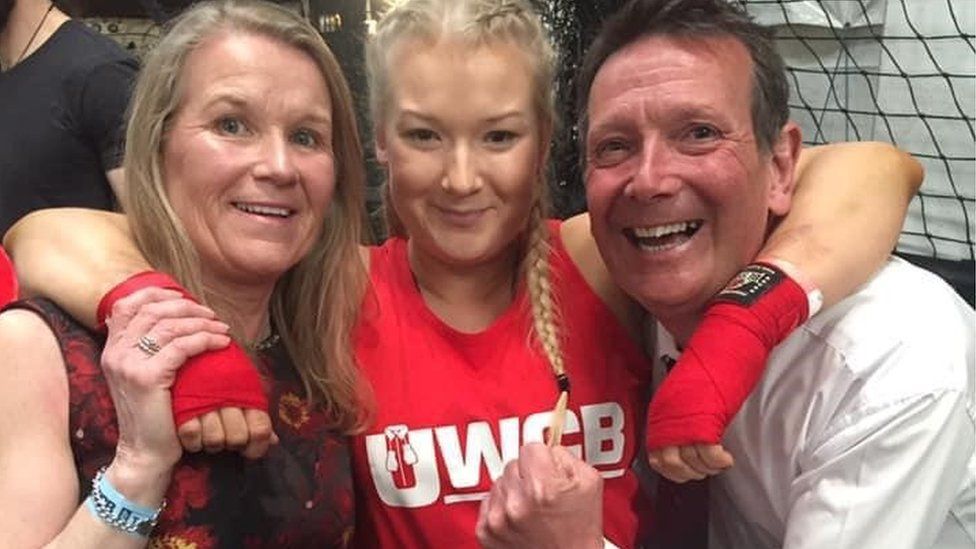 Bronwen Morgan with her parents at a charity boxing event