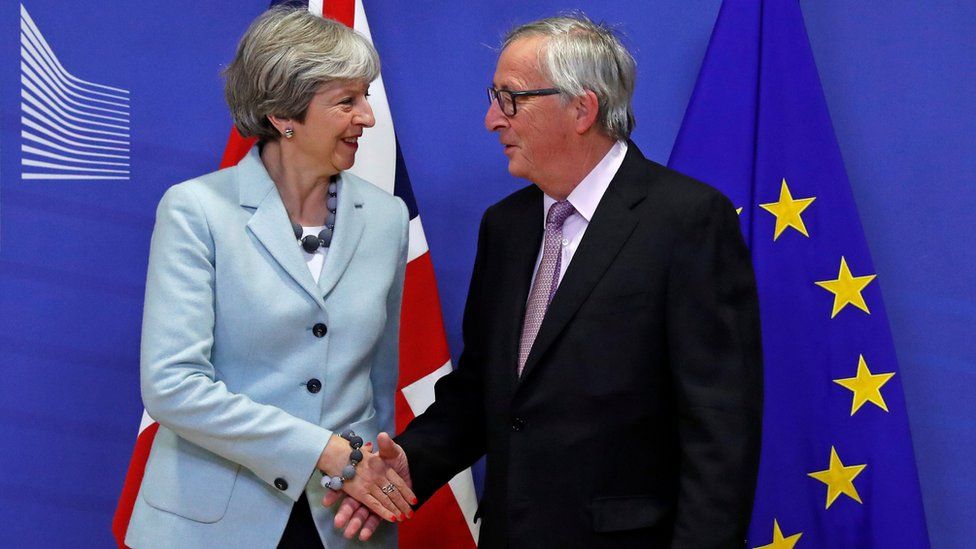 Theresa May shakes hands with Jean-Claude Juncker
