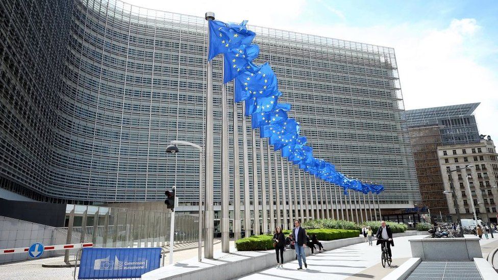 European Union flags wave in front of the Berlaymont Building (European Commission's headquarters) in Brussels