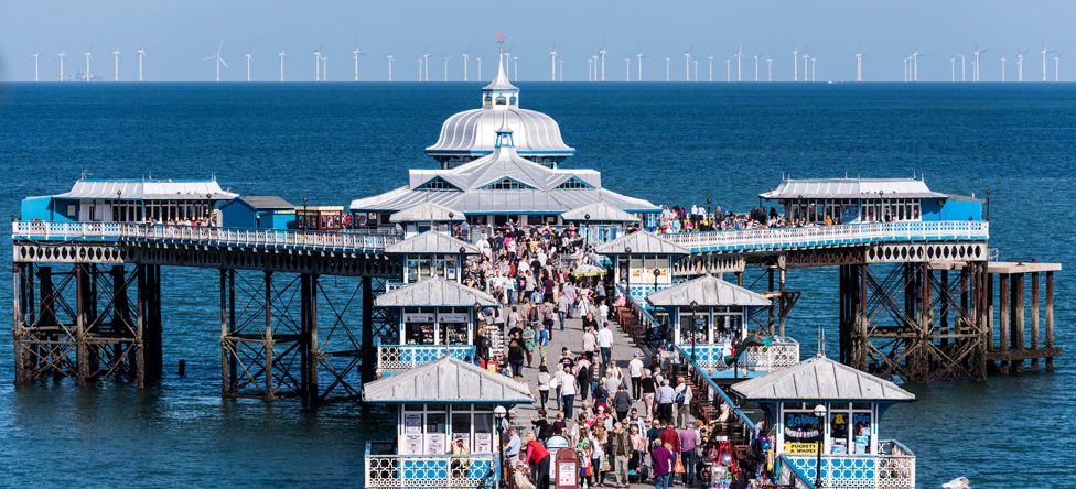 Picture of Llandudno pier with offshore wind turbines in the distance