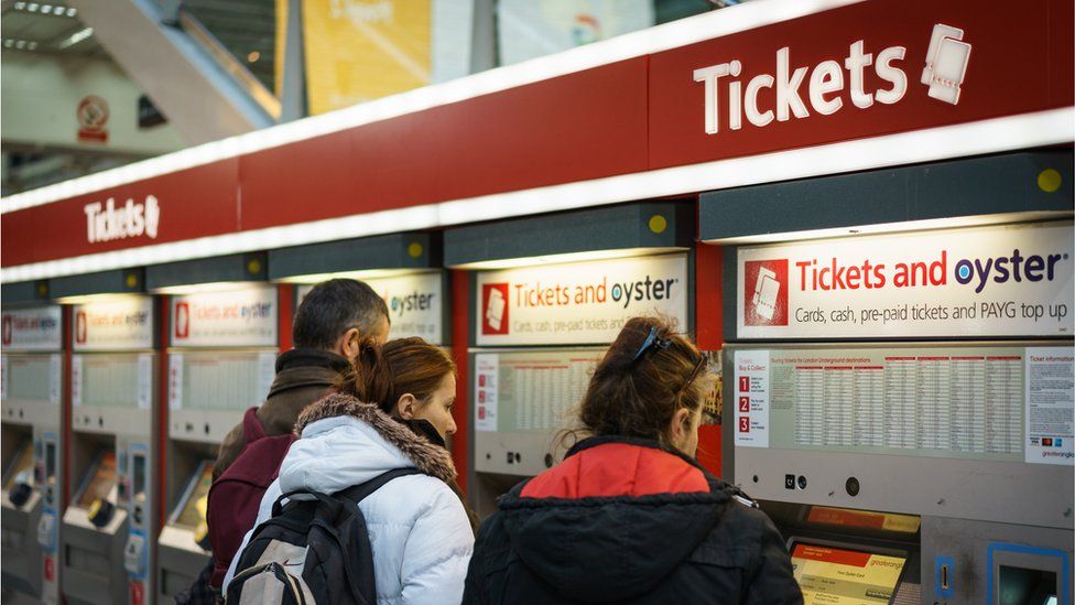 Tourists buy tickets at London Liverpool Street station