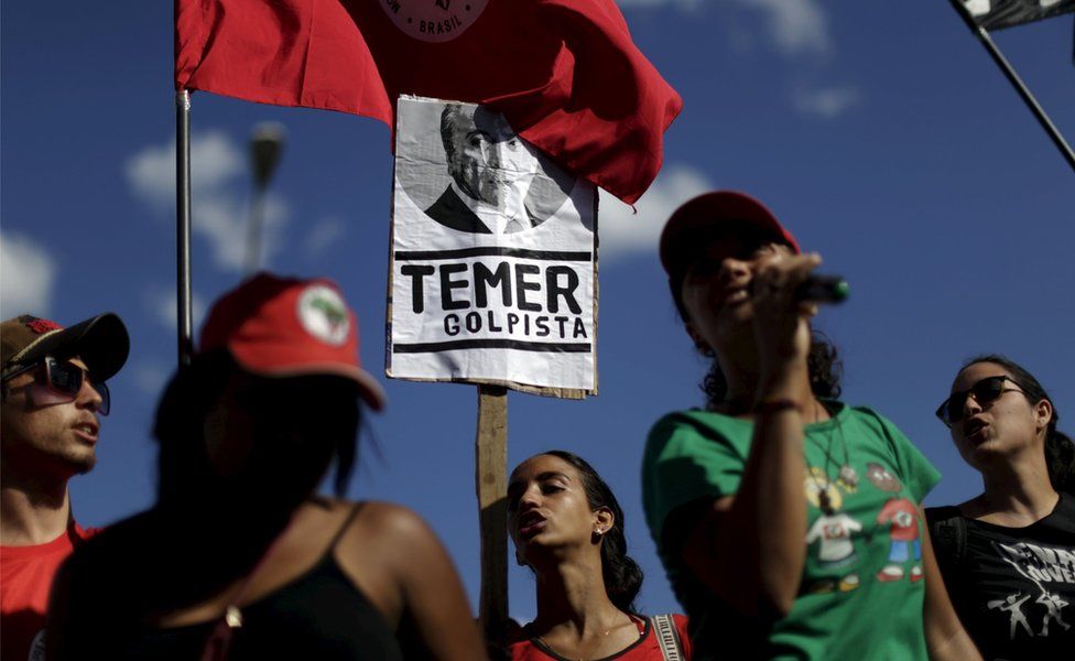 Members of social movements hold signs during a protest against Brazil's Vice President Michel Temer in front of Jaburu Palace in Brasilia, Brazil April 23, 2016. The placard reads: "Temer - putschist"