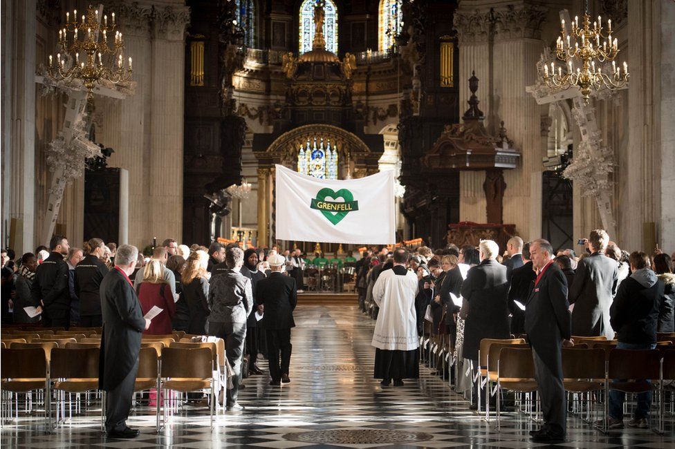 A Grenfell banner being carried into the cathedral