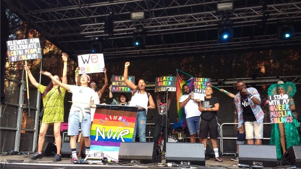 A group of people on stage at a Rainbow Noir event