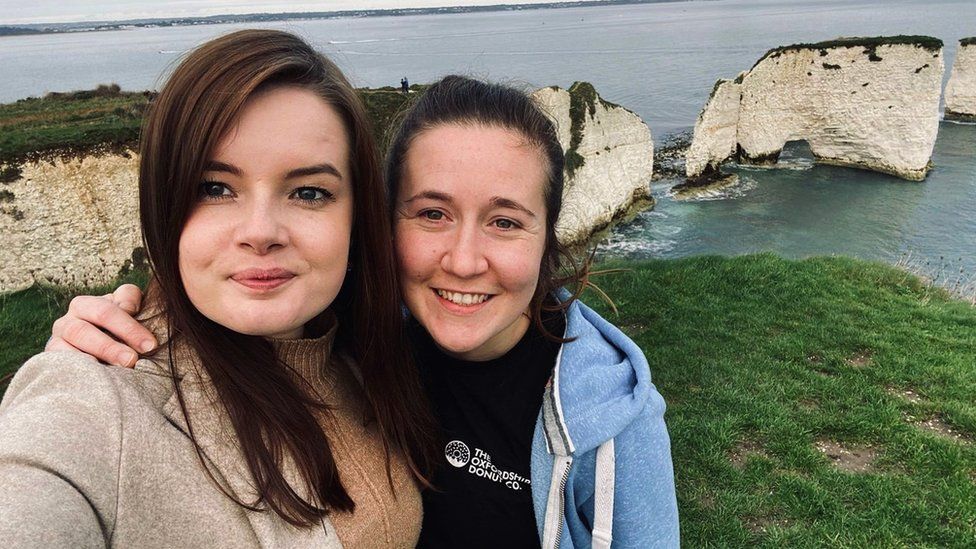 Two women take a selfie while out on a walk
