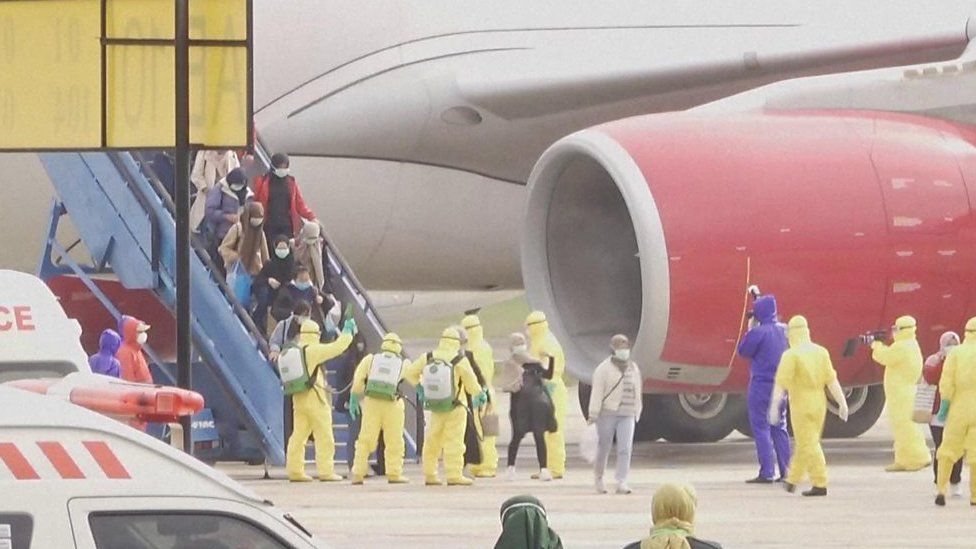 Indonesian evacuees from Wuhan being sprayed with disinfectant