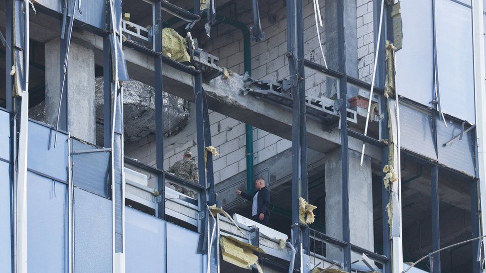 Members of Russia's security services investigate a damaged building following a drone attack in Moscow. Photo: 24 July 2023