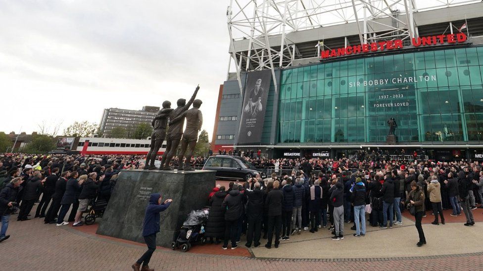 The funeral procession arrives outside Old Trafford in Manchester ahead of the funeral for the Manchester United and England great Sir Bobby Charlton