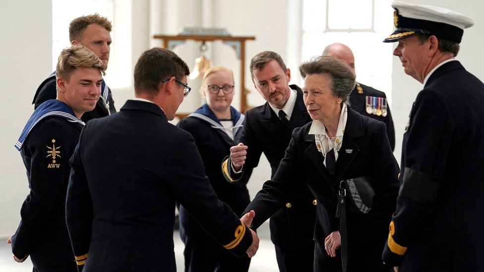 Princess Royal shakes a member of the Navy's hand