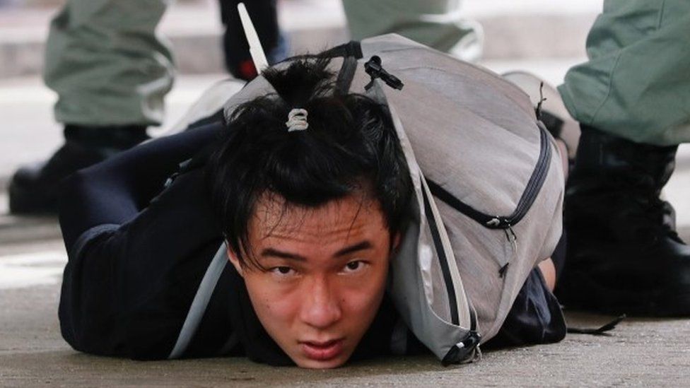 A man lies on the ground as he is detained by riot police during a march against the national security law at the anniversary of Hong Kong"s handover to China from Britain in Hong Kong, China July 1, 2020.