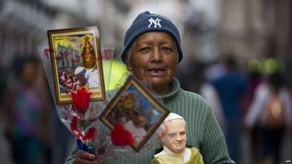 A woman sells images and figures of Pope Francis in Quito, Ecuador (06 July 2015)
