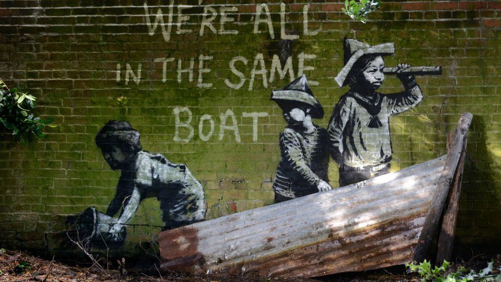 Banksy artwork in Oulton Broad, Suffolk, shows a group of children playing in a makeshift boat - painted on a drain bridge