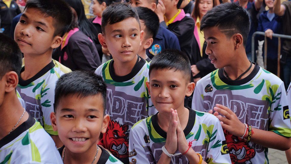 Twelve boys and their coach from the 'Wild Boars' soccer team arrive for a press conference for the first time since they were rescued from a cave