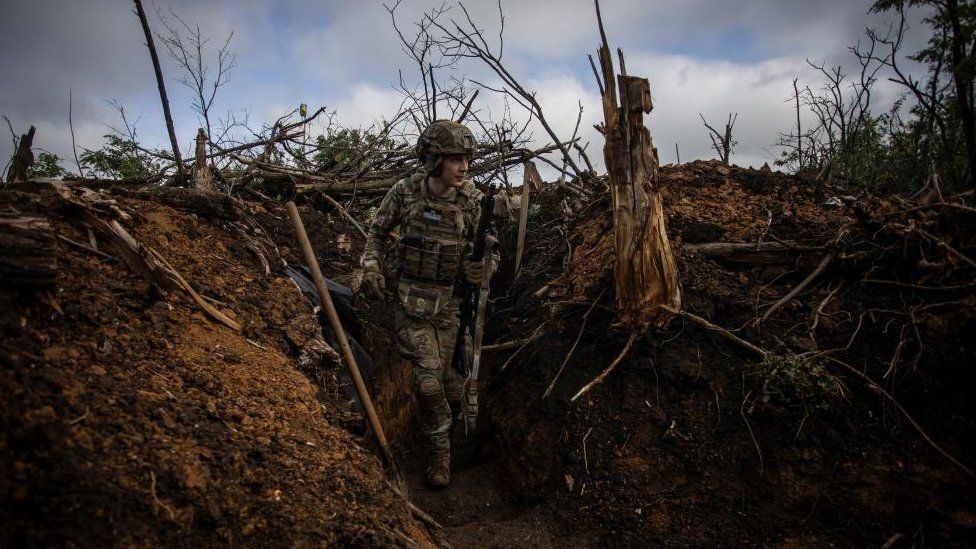 A Ukrainian worker  stands successful  a trench adjacent   Bakhmut, Ukraine