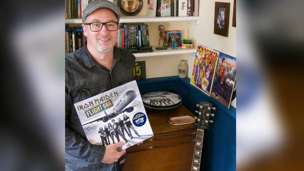 Colin Price holding an Iron Maiden LP