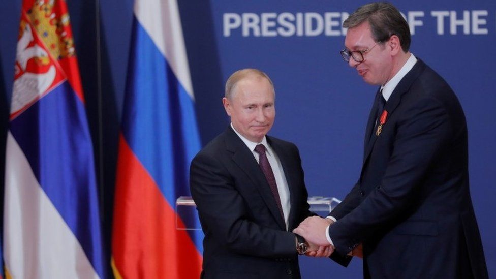 Russian President Vladimir Putin decorates Serbian President Alexandar Vucic with an order of Alexander Nevsky after their meeting in Belgrade in January