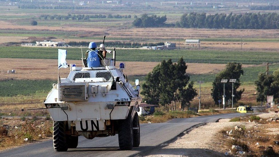 Vehicles of a convoy United Nations Interim Forces in Lebanon (UNIFIL) ride on a road along the border between Lebanon and Israel