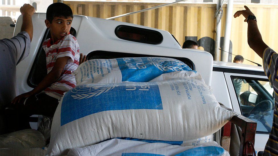 A boy looks at UNRWA aid bags. File photo