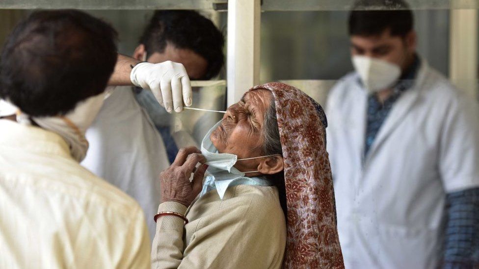 A health worker collecting a swab sample from a woman for Covid-19 testing, at Sector 30 District Hospital, on March 23, 2021 in Noida, India. (