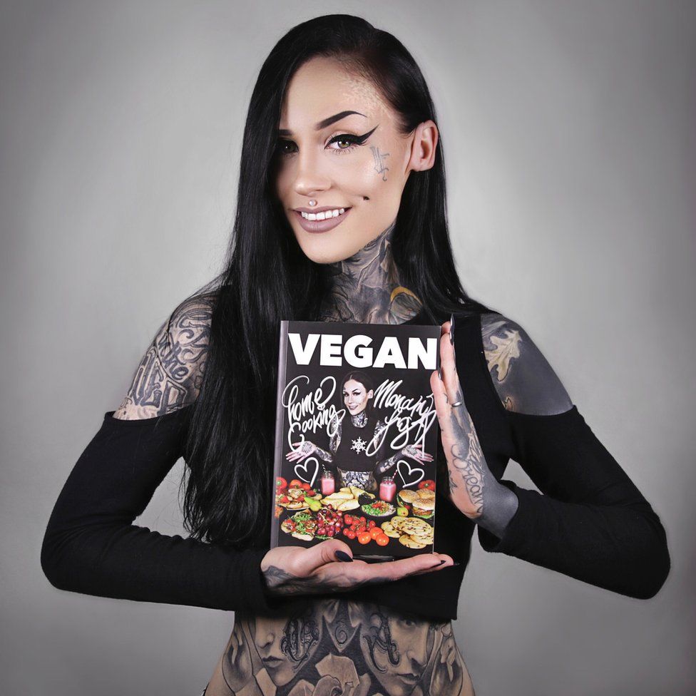 Monami Frost holding her book
