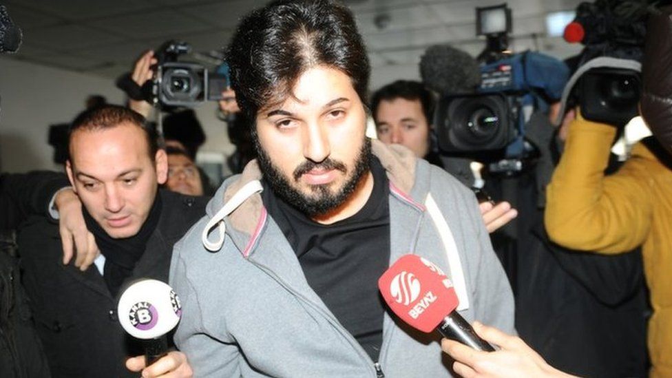 Detained Azerbaijani businessman Reza Zarrab is surrounded by journalists as he arrives at a police center in Istanbul on 17 December 2013