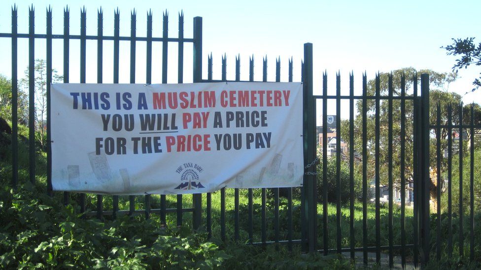 A protest sign outside a cemetery