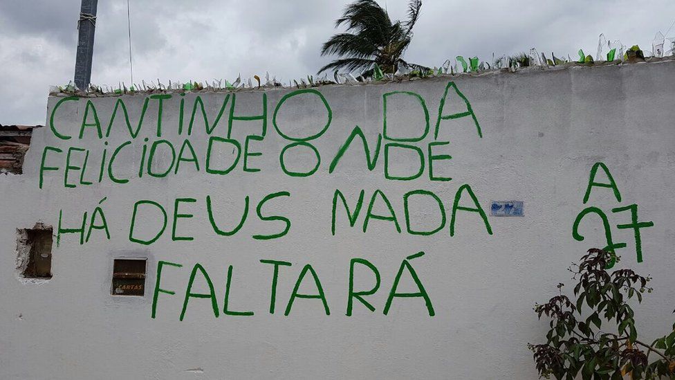 Writing on the wall of the home where Damiao and Sandra live reading: "Little corner of happiness where thanks to God, nothing is missing"