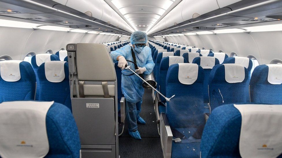 Member of Vietnam Airlines staff disinfects aircraft after flight - 4 February