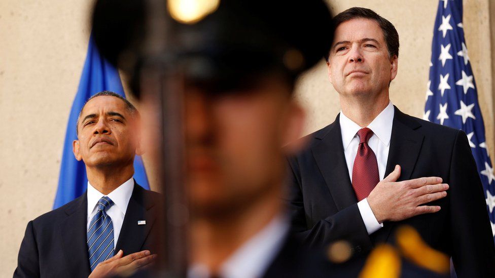 President Barack Obama and new FBI Director James Comey place their hands over their hearts during an installation ceremony for Comey at FBI Headquarters in Washington on 28 October, 2013.