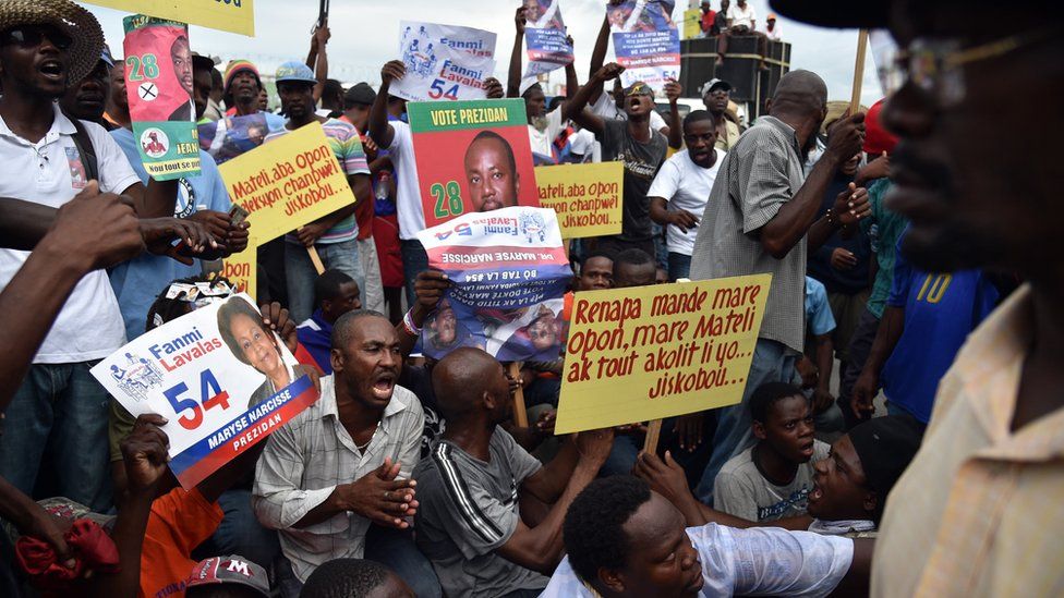 Demonstrators rally at the Ballot Tabulation Center in Sonapi, to protest against the Provisional Electoral Council, the election results and also to request an independent commission to review the election outcome, in Port-au-Prince on December 16, 2015.