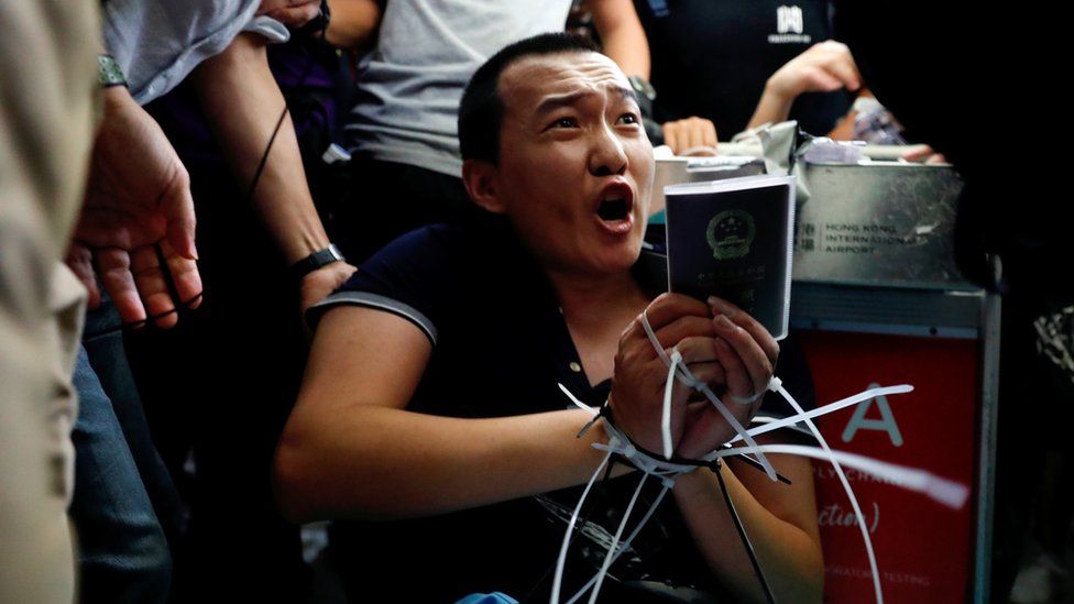 Fu Guohao, reporter of Chinese media Global Times website, is tied by protesters during a mass demonstration at the Hong Kong international airport, in Hong Kong, China, August 13, 2019.