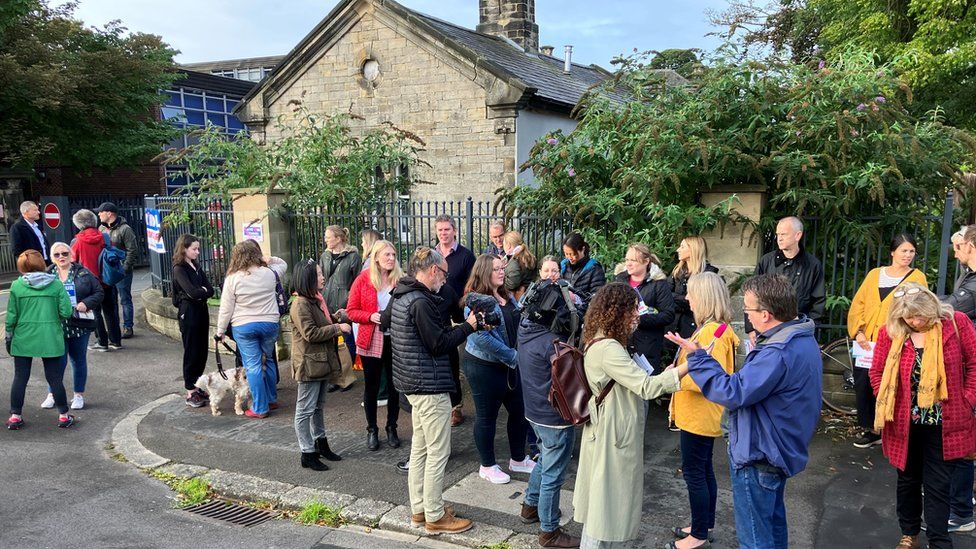 People gathered outside St Leonard's Catholic School in Durham in an Raac protest