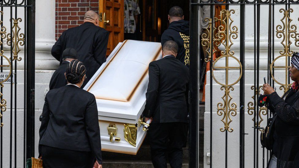 The coffin is carried into the church at Jordan Neely's funeral