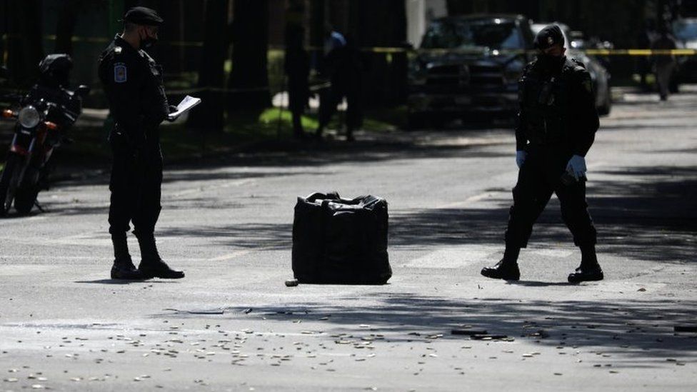 Police officers stand next to bullet casings in the upscale neighbourhood of Lomas de Chapultepec, in Mexico City, Mexico June 26, 2020