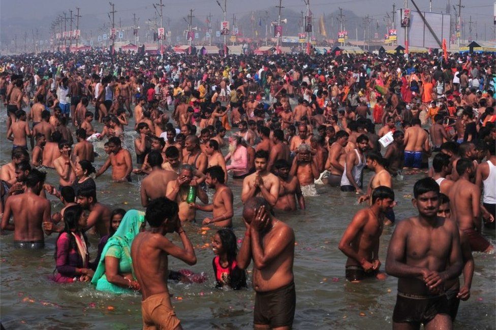 Hindu devotees take a holy dip in the waters of Sangam, the confluence of the Ganges, Yamuna and Saraswati rivers to mark Mauni Amavasya, the most auspicious day during the annual religious festival of Magh Mela, amidst the spread of the coronavirus disease (COVID-19) in Prayagraj, India, February 11, 2021.