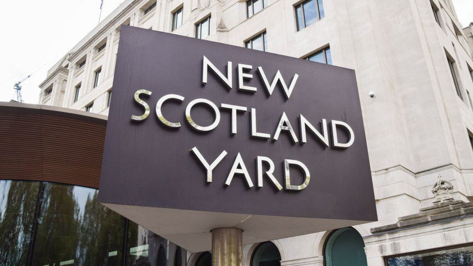 An image of the New Scotland Yard sign outside the Met Police headquarters in London