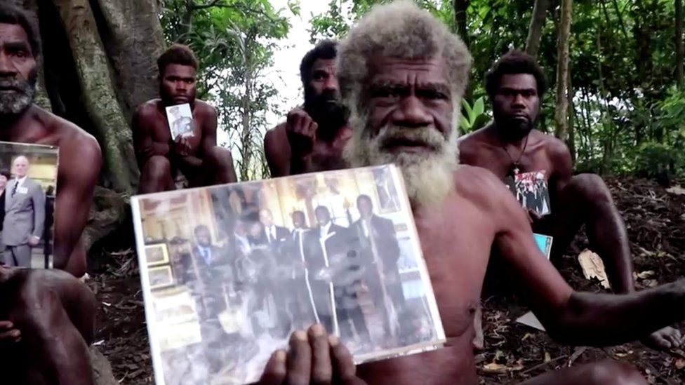 Ikunala village Chief Yapa holds photos of himself and four other local men with Britain"s Prince Philip, taken during their 2007 trip to England, as he sends their condolences after the prince passed away at age 99 on Friday, in Ikunala, Tanna island, Vanuatu April 11, 2021.