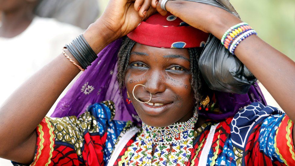 A Fulani woman fixes her head scalf on the street of Dapchi, Yobe state, Nigeria February 27, 2018