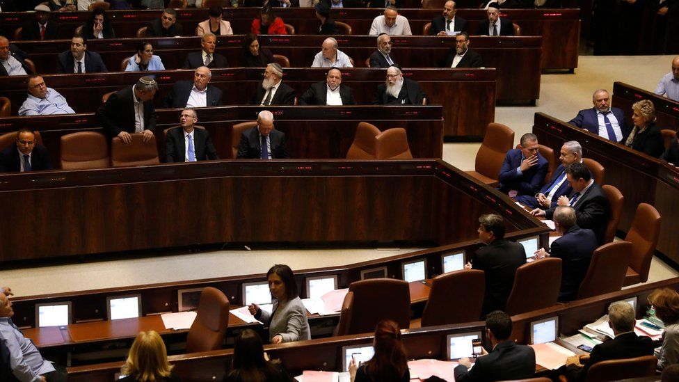 Israeli Prime Minister Benjamin Netanyahu (C-R) and MPs take part in a Knesset(parliament) session in Jerusalem on 26 December 2108
