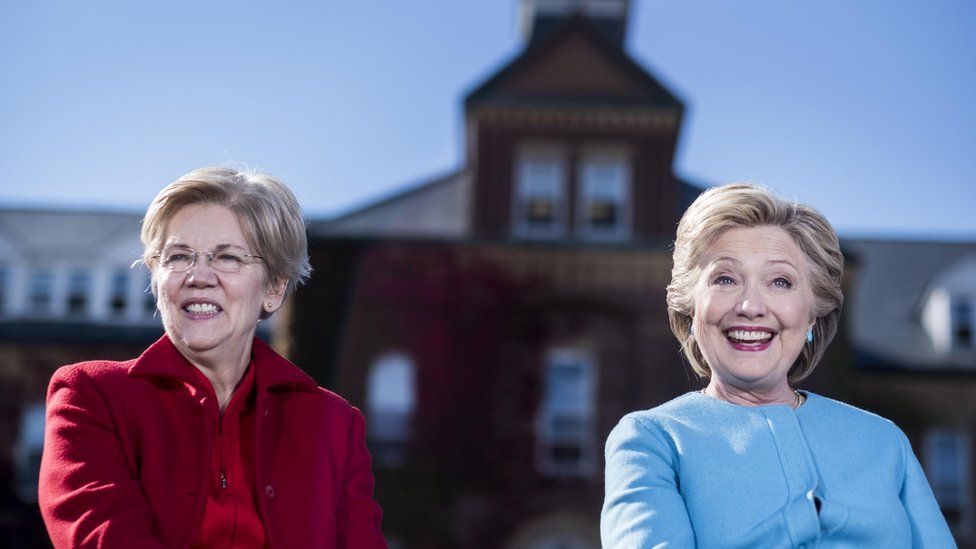 Elizabeth Warren sits next to Hillary Clinton at a campaign event in 2016