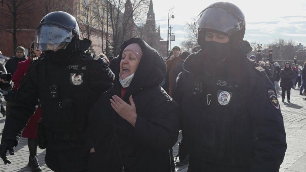 A woman being led away in Moscow
